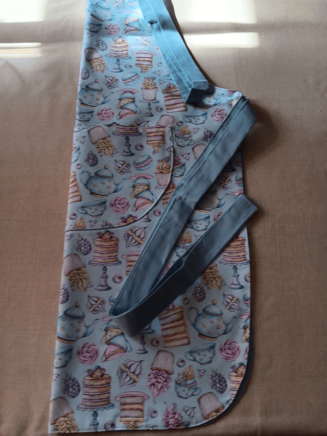 Adult Kitchen Apron Tea and Cakes Patterned Cotton Fabric with Front pocket and Pale blue lining, waist ties and adjustable neck ties