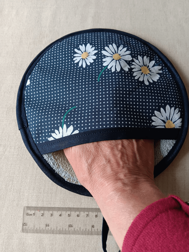 Round Hot Pot Grab Mat Navy Daisies Cotton Fabric with heat resistant filling and mint green towelling 
