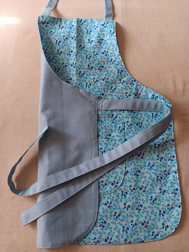 Childs Kitchen/Play Apron  Blue Bows Cotton Fabric with Front pocket and pale blue lining, waist ties and adjustable neck tie