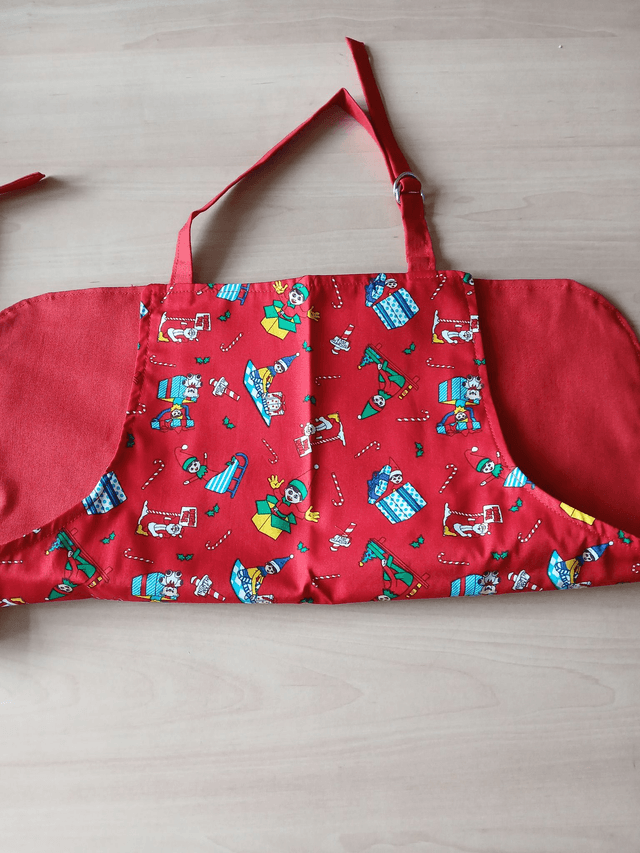 Childs Kitchen Play Apron Festive Patterned Cotton Fabric with Front pocket and Red lining, waist ties and adjustable neck ties