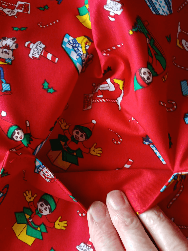 Childs Kitchen Play Apron Festive Patterned Cotton Fabric with Front pocket and Red lining, waist ties and adjustable neck ties