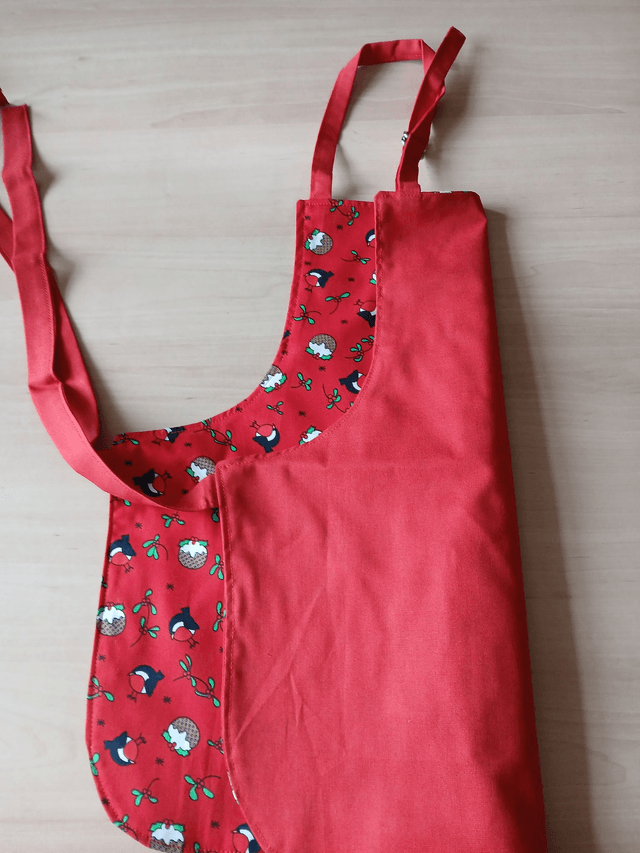 Childs Kitchen Play Apron Pudding Patterned Cotton Fabric with Front pocket and Red lining, waist ties and adjustable neck ties (1)