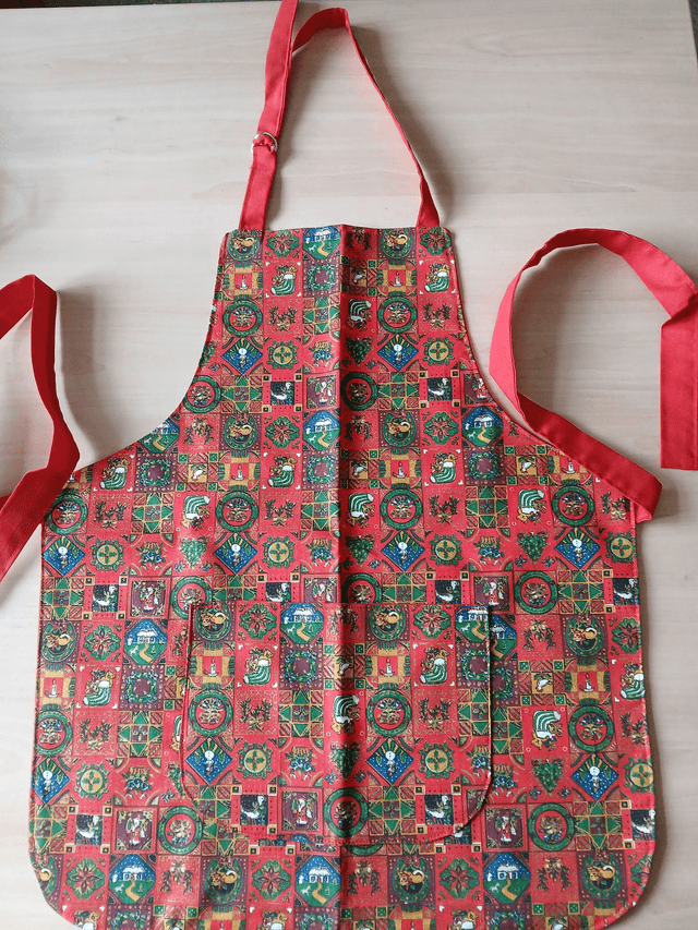 Childs Kitchen Play Apron Festive Patterned Cotton Fabric with Front pocket and Red lining, waist ties and adjustable neck ties