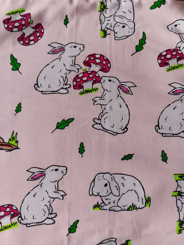 Childs Kitchen Play Apron Pink Bunnies Patterned Cotton Fabric with Front pocket and pink lining, waist ties and adjustable neck ties 