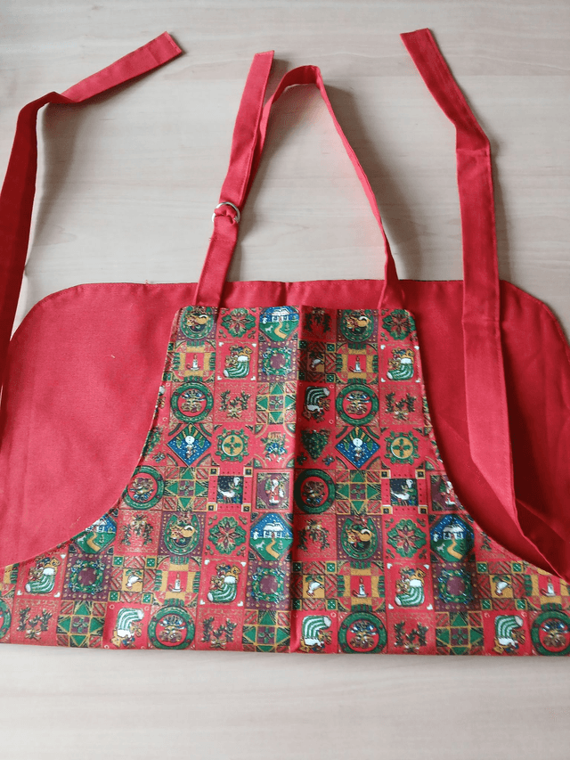 Childs Kitchen Play Apron Festive Patterned Cotton Fabric with Front pocket and Red lining, waist ties and adjustable neck ties