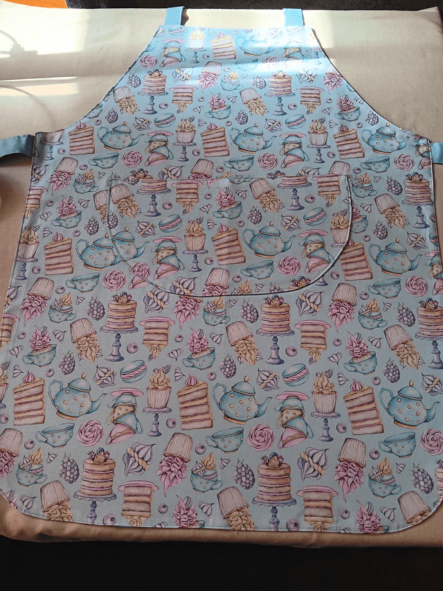 Adult Kitchen Apron Tea and Cakes Patterned Cotton Fabric with Front pocket and Pale blue lining, waist ties and adjustable neck ties