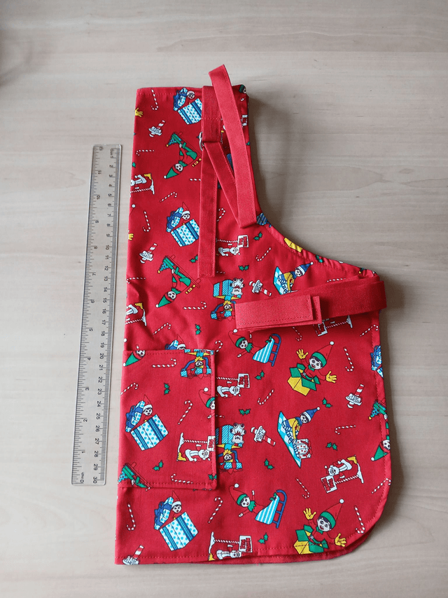 Childs Kitchen Play Apron Festive Patterned Cotton Fabric with Front pocket and Red lining, waist ties and adjustable neck ties