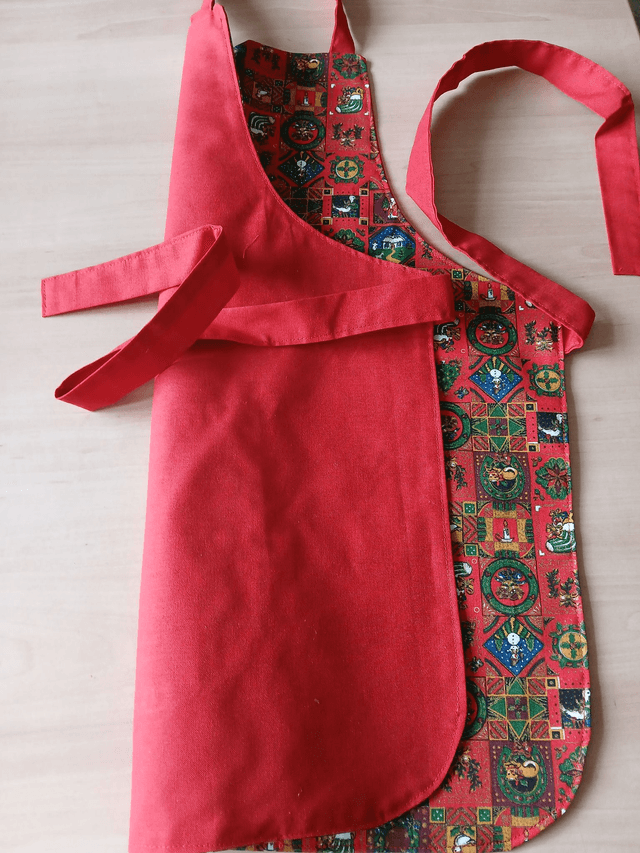 Childs Kitchen Play Apron Festive Patterned Cotton Fabric with Front pocket and Red lining, waist ties and adjustable neck ties