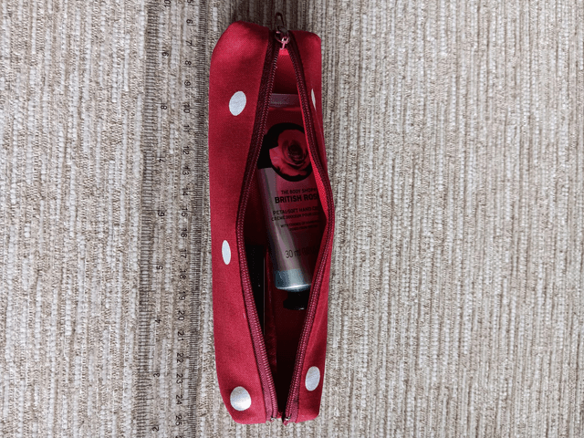 Small Box Shaped Cosmetic Bag Red background with white spots, Red Waterproof Lining, and Red Zip.
