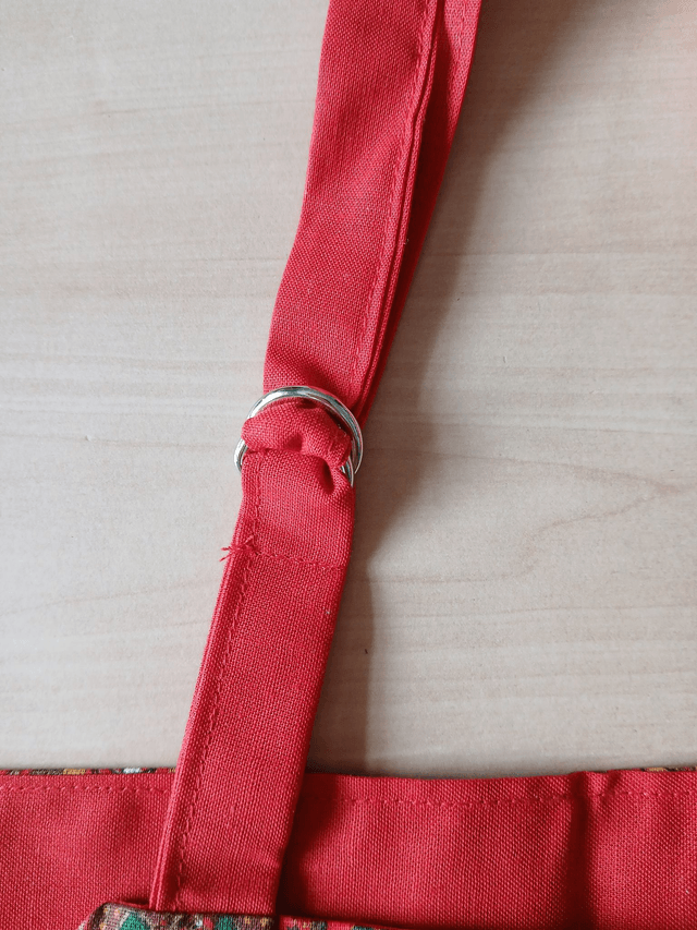 Childs Kitchen Play Apron Festive Patterned Cotton Fabric with Front pocket and Red lining, waist ties and adjustable neck ties