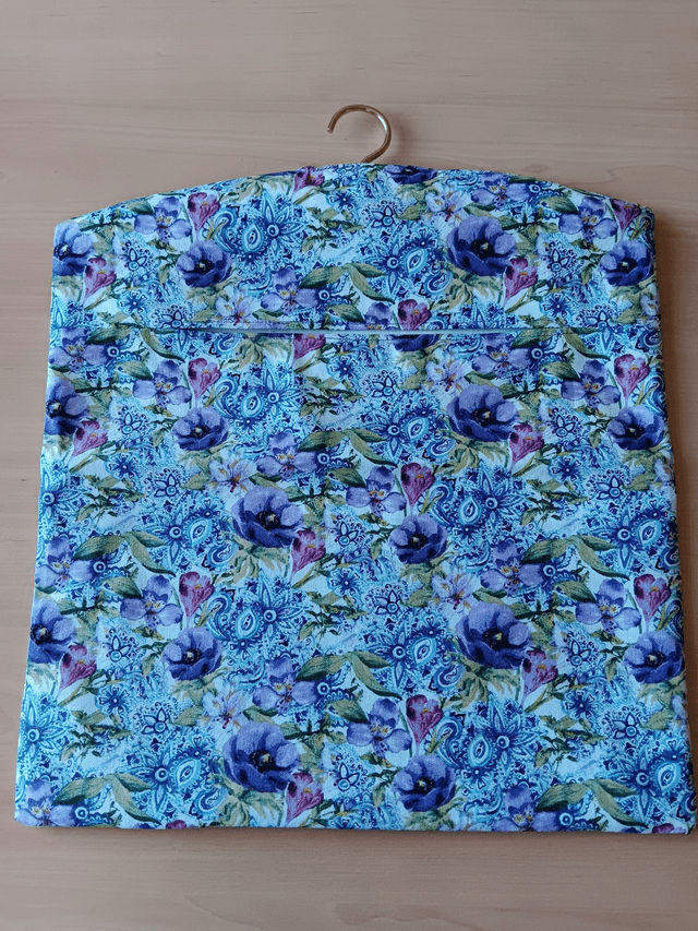 Hand made Peg Bag with wooden coat hanger. Floral print fabric with plain lining.