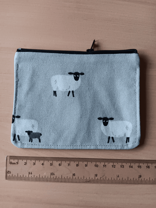 Sheep on a grey Background Zipped Purse with Red Waterproof Lining, and Black Zip.
